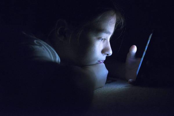 teenager on phone at night